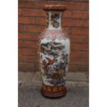 A large early 20th century Chinese vase on a newer wooden base depicting pheasants amongst