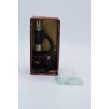 An Eclipse small microscope with glass slides. Approx 18cm tall.