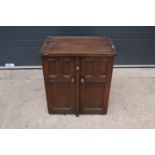 A wooden 20th century Priory style sideboard with a fold-out table top. Largest dimensions 138 x