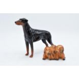 A Beswick Doberman 3121 together with Three Puppies 917 (2). In good condition with no obvious