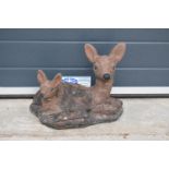 A vintage garden ornament in the form of a deer and fawn.