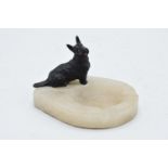 A painted cold cast bronze model of a Westie mounted onto an onyx or similar base in the form of