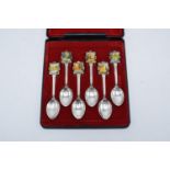 A cased set of 6 souvenir teaspoons by Perfection with a Waltzing Mailtida/ New Zealand design (