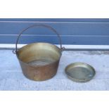 A late 19th/ early 20th century solid brass jam pan together with a brass dish (2). 33cm diameter.
