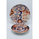 A pair of early 20th century Japanese Imari plates with shaped edges, one being 31cm diameter and