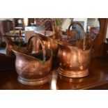 A pair of copper coal buckets to include a hammered Victorian bucket together with a later