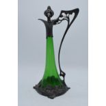 A WMF art nouveau pewter claret jug with threaded stopper, tapering green glass body and designed