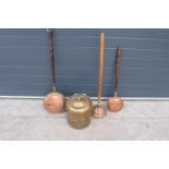 A collection of metal ware to include a brass coal bucket, 2 copper bed pans and a similar item (4).