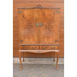 An early 20th Century Queen Anne style walnut drinks / cocktail cabinet with the doors opening to