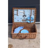 A vintage mid to late 20th century picnic set in a wicker travelling case (part set).