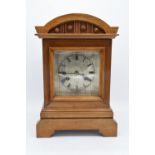A 20th century wooden cased mantle clock 'J Unghans' with bevel-edged glass and an associated key.