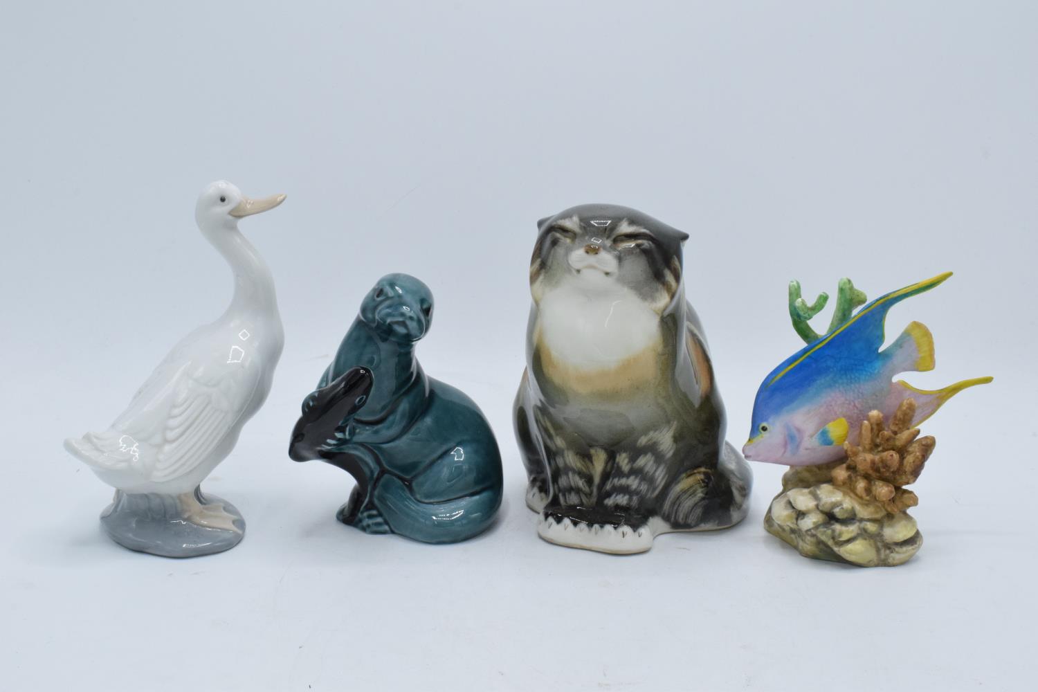 A collection of pottery to include a USSR Cat 2003, Poole pottery Otter, Nao duck and a Royal
