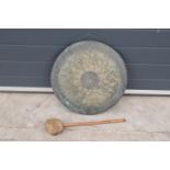 A large hanging gong with striker. 48cm diameter
