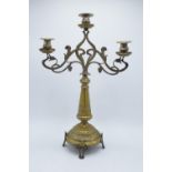 A large brass Art-Nouveau candelabra raised on 4 feet. 49cm tall. It is in good condition