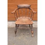 A late 19th century elm or similar wood captain's chair. 79cm tall. In good functional condition