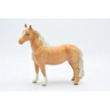 Beswick Pinto pony in Palomino colourway 1373. 17cm tall. In good condition with no obvious damage