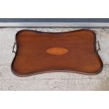 Edwardian wooden shaped rectangular tray with brass handles and an inlaid motif. 57 x 37cm. In