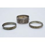 A collection of silver bangles / bracelets with floral decorations. 79.5 grams. In good condition.