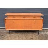 A retro vintage 1950s mid century E Gomme G-Plan light oak 'Librenza' sideboard raised on 4 black