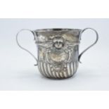 A large silver porringer decorated with an embossed cherub decoration. 339.7 grams. In good