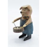 A Schuco circa 1930s clockwork toy figure in the form of a pig with a drum. Based on the Three