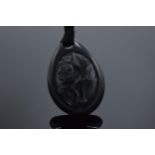 A large Victorian Whitby Jet carved pendant. 5.5cm tall. In good condition.