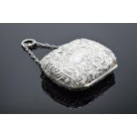 A miniature silver ornate embossed ladies purse with fitted interior. 6cm wide. Birmingham 1889.