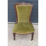 Edwardian green upholstered parlour chair with carved decoration. 90cm tall.