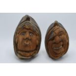 A pair of 20th century carved coconuts or similar in the form of tribal heads (2). Tallest 23cm