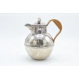 A hallmarked silver Jersey style cream jug with wicker style handle. Gross weight 315.6 grams.
