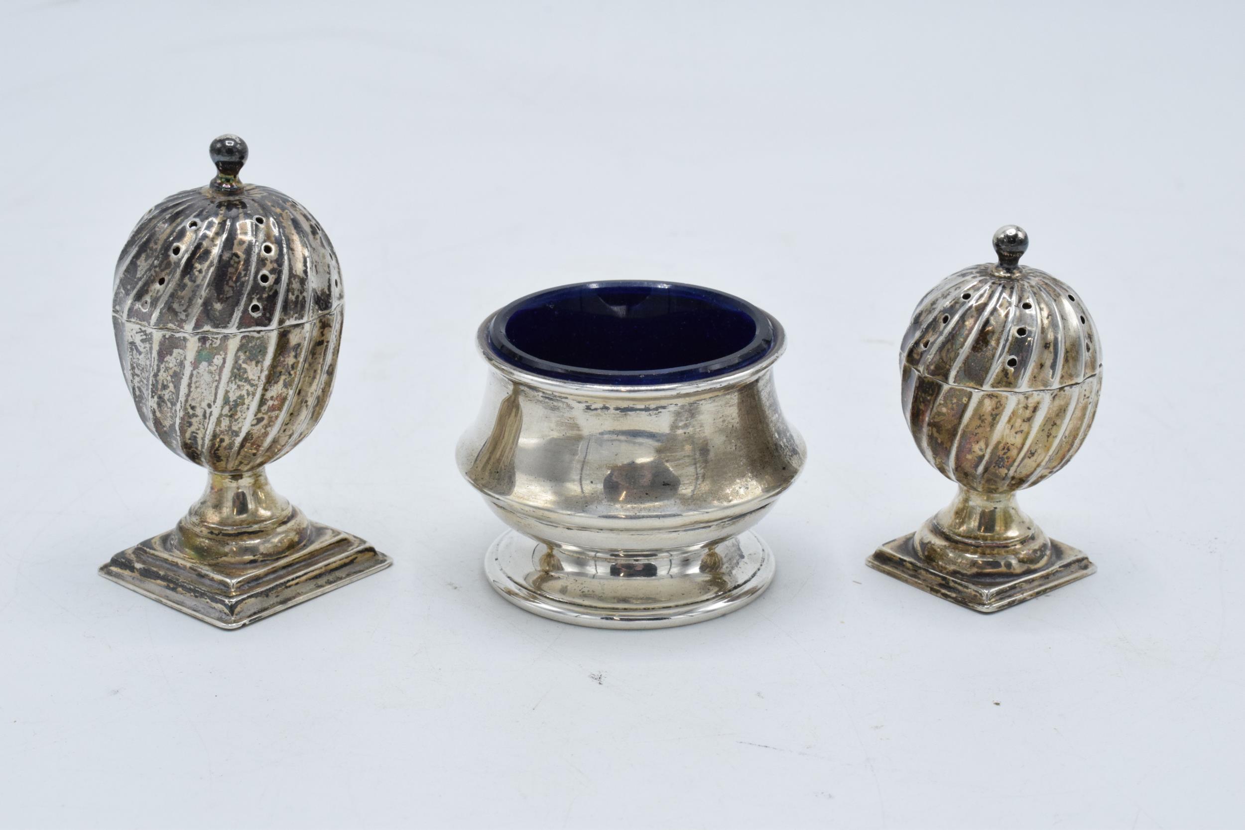 A collection of hallmarked silver items to include acorn shaped cruet shakers (42.3 grams of silver)