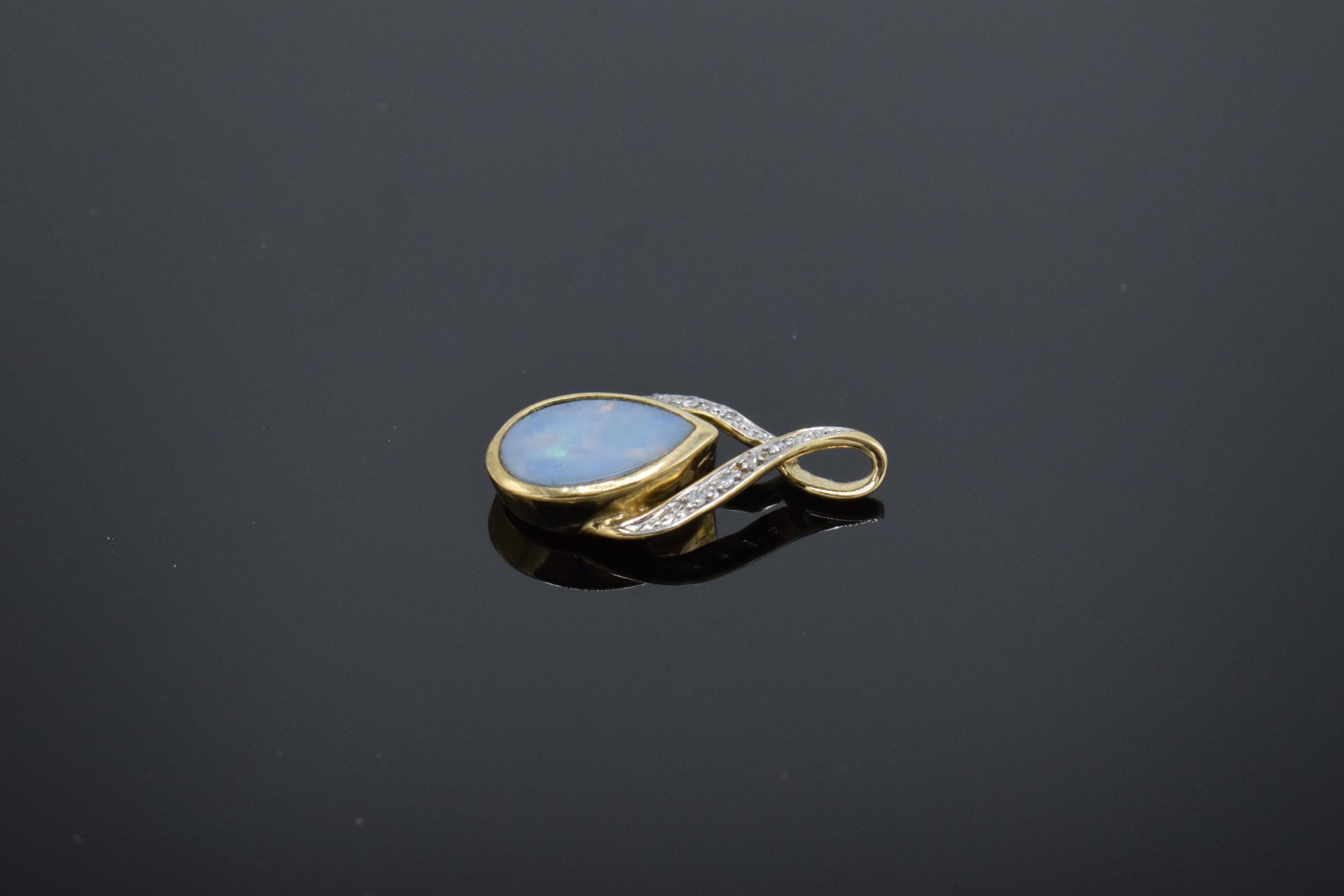 A 9ct gold pendant set with opal stone and illusion set diamonds. 1.0 grams. - Image 3 of 4