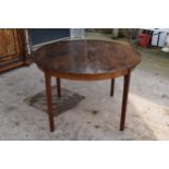 A mid century retro A H Mcintosh and Co of Kirkcaldy expanding circular dining table. One leaf.