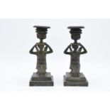 A pair of 19th century Grand Tour Bronze candlesticks depicting ladies with wings holding an urn