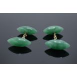 A pair of jade or similar hard stone cufflinks.