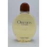 A large dummy shop display glass scent bottle for Calvin Klein 'Obsession For Men'. 25cm tall. In