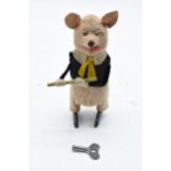 A Schuco circa 1930s clockwork toy figure in the form of a pig with a flute (with key). Based on the