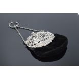 An ornate silver ladies velvet purse with a ball clasp depicting a hunting scene. Hallmarked for