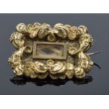 Tested as 9ct gold Georgian mourning brooch with locks of hair. Gross weight 2.1 grams. 22mm wide.