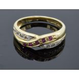 A 14ct gold ladies ring set with diamonds and ruby stones. UK size N/O. Gross weight 3.1 grams.