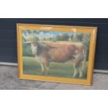 A framed jigsaw of a Longhorn cow in a wooden frame