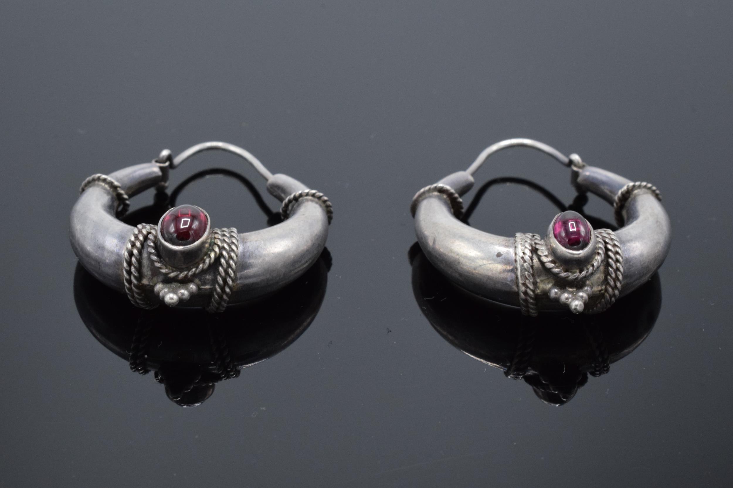 Continental silver thick earrings set with cabachon garnet stones earrings (unmarked). 10.6 grams