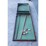 A 19th century folding table-top bagatelle in a mahogany case with green felt interior by Thurston
