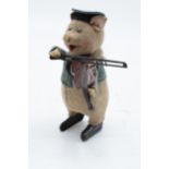 A Schuco circa 1930s clockwork toy figure in the form of a pig with a violin. Based on the Three