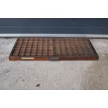 An early 20th century wooden printers letter block tray / rack with brass tacts. 83 x 39cm, (1271).