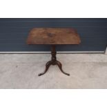 A 19th century oak tripod table. 72cm tall. In good functional condition though as expected are