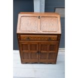 A 20th century wooden bureau in the Old Charm style. 77 x 45 x 100cm.