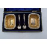 A pair of silver salts together with matching spoons in a fitted case. Birmingham 1899. 26.8 grams.