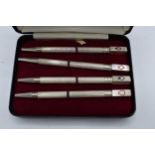 A sterling silver set of 4 bridge pencils with the tops of the pencils depicting the 4 suits. 9cm