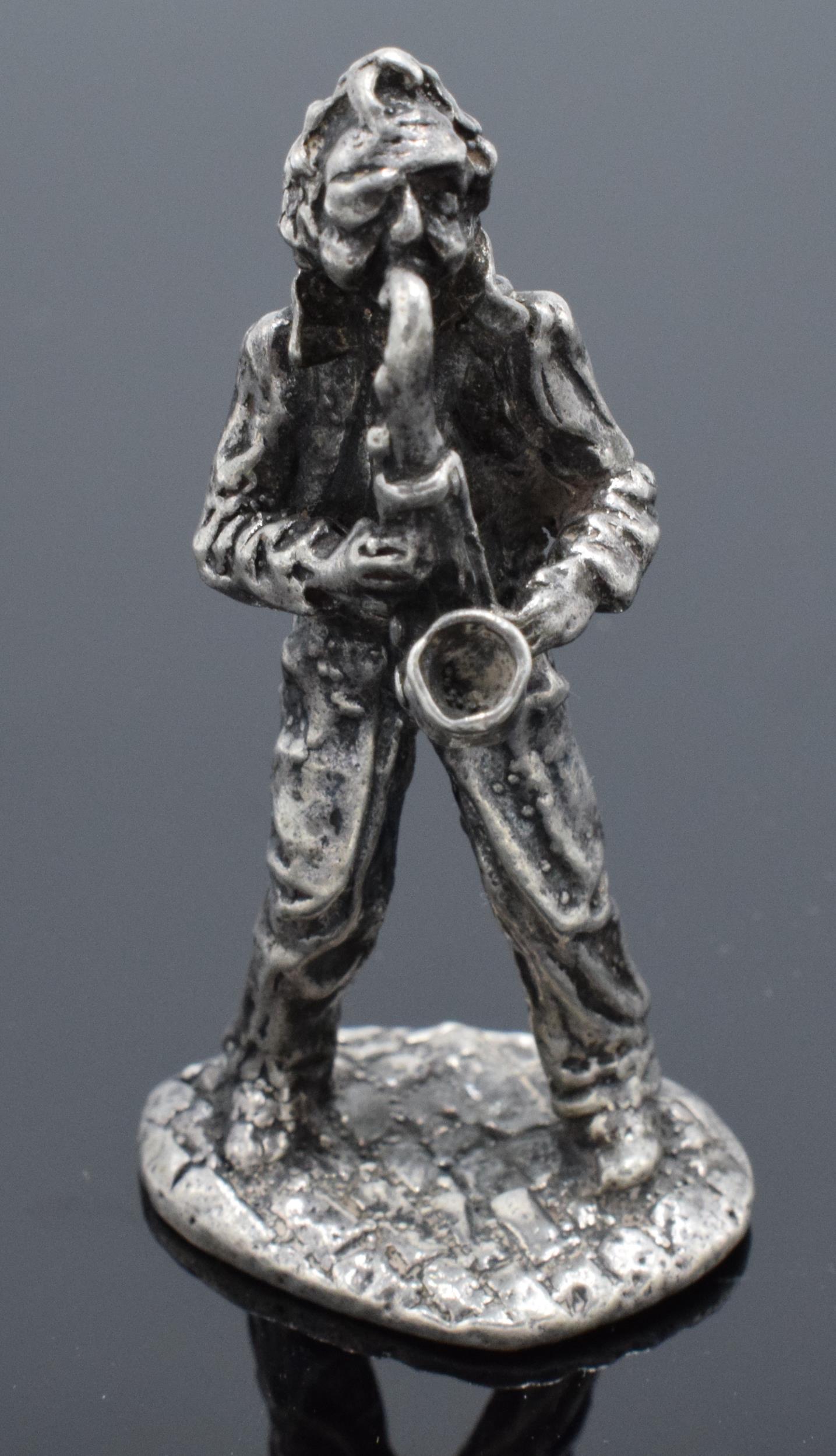 A silver model of a male saxophonist. With London import silver marks for late 20th century. 37.4